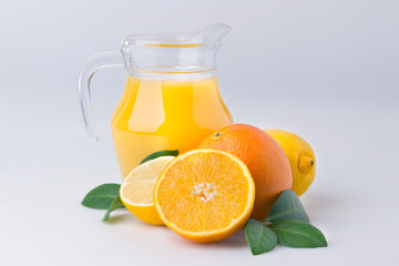 Fresh orange juice and citrus fruits lime lemon grapefruit in a jar white background healthy concept