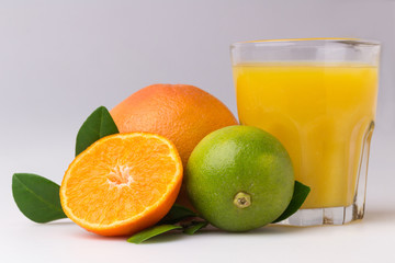 Glass of fresh citrus fruit Juice with green leaf isolated on white background