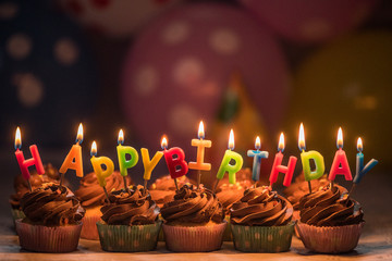 happy birthday lit candles on a birthday cake 