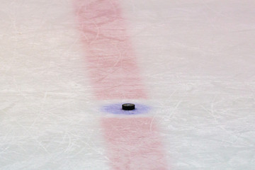 Hockey puck on ice stadium 