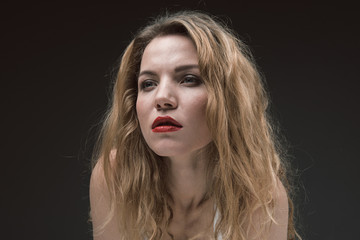 Portrait of beautiful calm lady with red lips looking ahead wistfully. Isolated on background