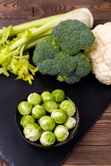 Top view on cabbage, broccoli, cauliflower, Brussels sprouts and celery - the concept of vegetarian food.