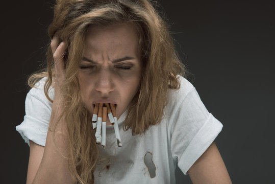 Female person with revolting expression expectorating rollups of mouth. Isolated on background