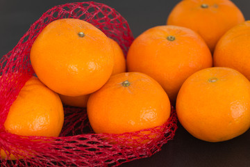 tangerines on the dark stone table.