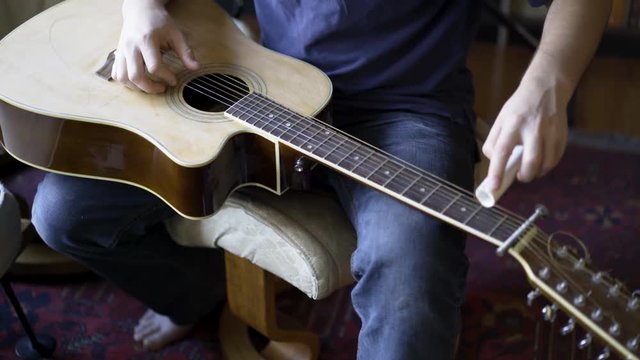 Looking down on a beater slide guitar with pvc sider.