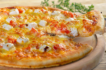 pizza 4 cheese on a wooden background