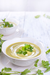 Cream soup with green peas and fresh herbs. Summer dinner. Healthy diet . Soup from vegetables. Free space for text. Vertical photo.
