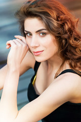 Young woman outdoors portrait. Soft sunny colors on a summer sunny day.
