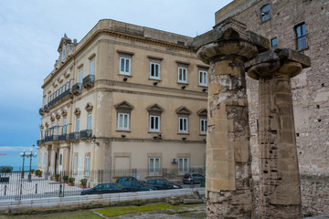 Horizontal View of the two Most Ancient Doric Columns of the Magna Greece on Blur Background. Taranto, South of Italy