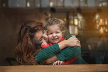 My sweetheart. Portrait of affectionate mother kissing her little daughter cheek with gentleness....