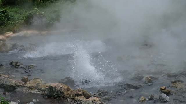 Hot springs (Geyser type) with rocks and green jungle.Pongduet Pa Pae Hotspring, Chiang Mai Province,Thailand 