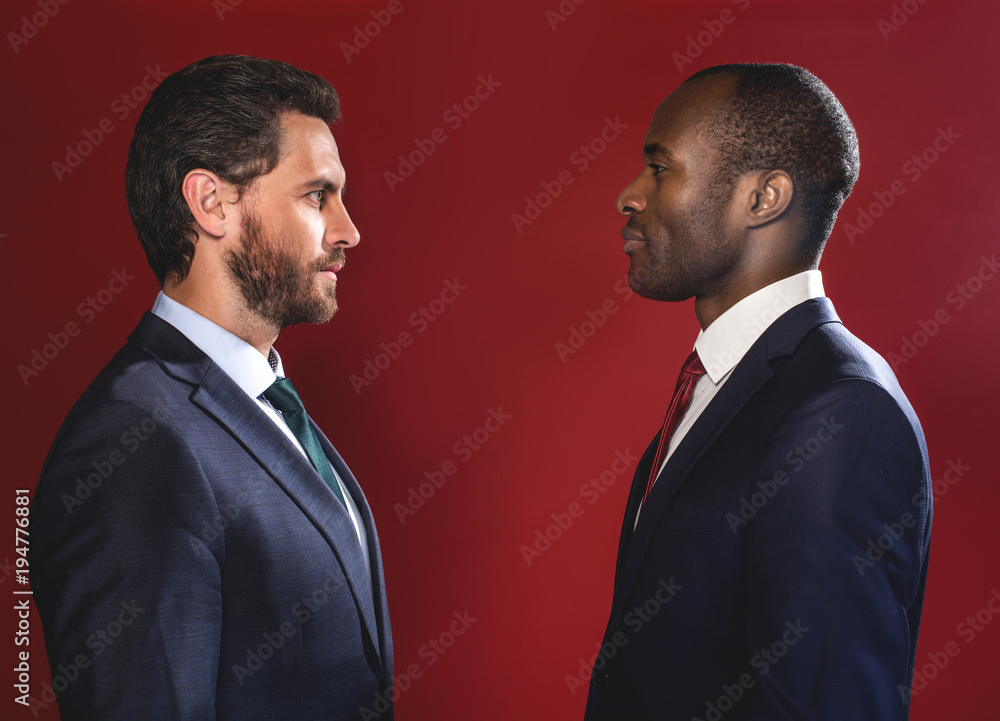 Poster rivalry concept. profile of two guys are standing opposite and looking at each other defiantly. isol