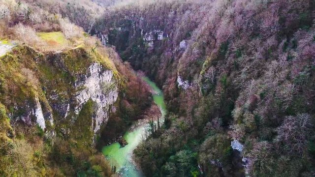 Mountain river flowing landscape. Clip. Aerial beautiful mountain stream, river surrounded by green trees with crystal clear waters winding through the mountains