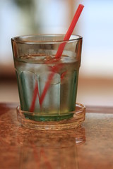 Close up ice drink of water and orange straw