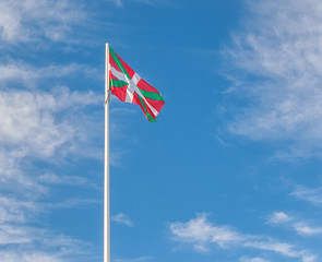 Basque flag waving in the wind against the sky
