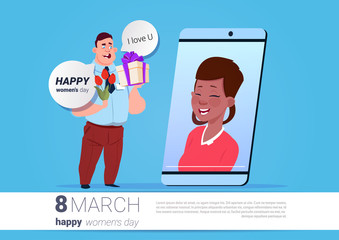 Man Greeting Girl White International Women Day Online With Smart Phone Holding Flowers And Present Over Background With Copy Space Flat Vector Illustration