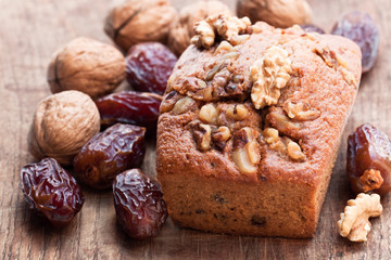 Homemade  date and walnut loaf cake on old wooden table
