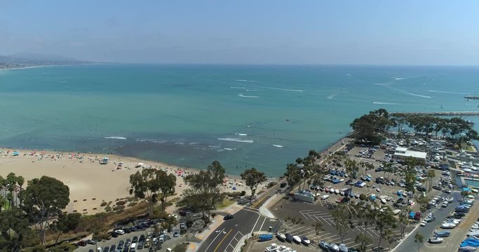 DANA POINT, California. Doheny State Beach. A sunny day beach scene with people engaged in beach activities. Surfers. Aeria 4K