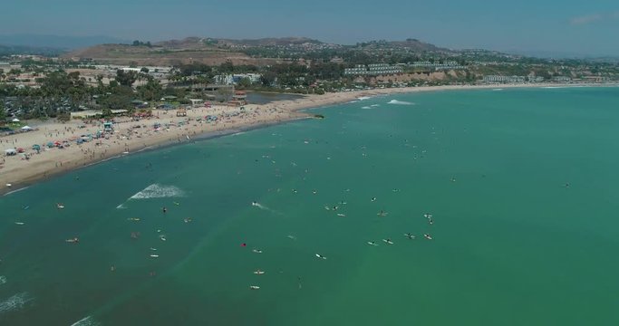 DANA POINT, California. Doheny State Beach. A sunny day beach scene with people engaged in beach activities. Surfers. Aeria 4K