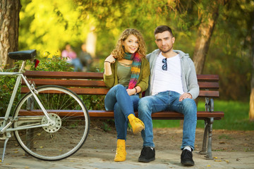 Young couple in park with bicycle