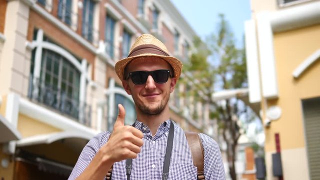 Portrait Of Tourist Man In Hipster Hat And Sunglasses Sightseeing In City