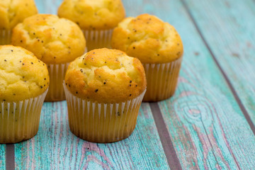 Lemon Poppyseed Muffins on a Blue Wooden Table