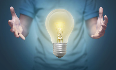 People hand holding bright lights bulb