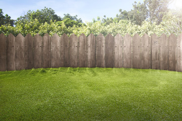 Fototapeta premium Wooden fence on green garden