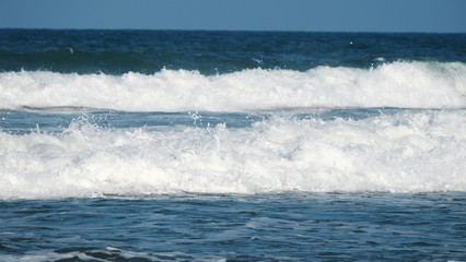 Obraz premium Beach background / A beach is a land alongside a body of water which consists of loose particles. The particles composing a beach are typically made from rock, such as sand, gravel, shingle, pebbles