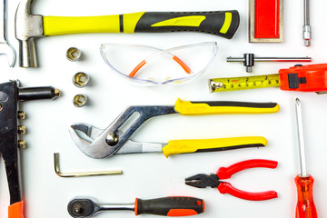 Set of construction tools on white background as wrench, hammer, pliers, socket wrench, spanner, tape measure, electric drill,safety glasses, screwdriver