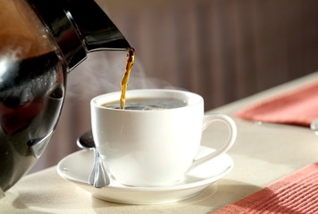 Brew hot coffee, pour hot coffee in a glass of smoke..Food concept and good morning