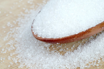White sugar on wooden spoon.Food and health concepts
