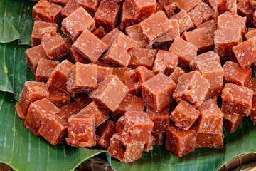 Thai traditional oganic food,  brown sugar made of cane sugar jaggery, by evaporation of the sap of sugar cane juice.