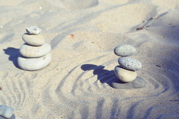 Fototapeta na wymiar Balanced rocks in zen garden sand circles