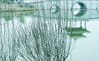 Reflection of the ancient bridge in the lake