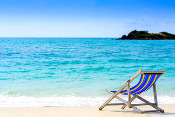 A seat on the beach with blue sea background