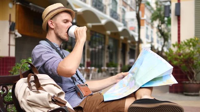 Man Tourist Reading Map And Drinking Coffee. Travel Leisure Activity Concept.