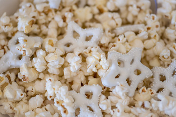 overhead closeup of popcorn and pretzels in bowl in wnter
