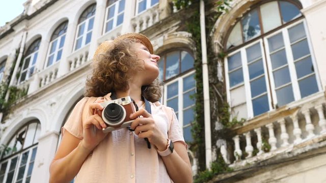 Young Woman Tourist Taking Photos With Hipster Camera In City