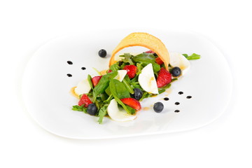 fresh vegetable salad with strawberries on white isolated background