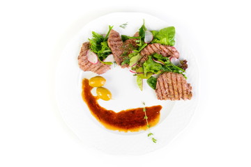 Fried meat with sauce and fresh vegetables isolated on white background