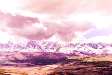 Beautiful view of the mountain range under the pink clouds. Mountain landscape in pastel colors