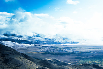 Views of the snow capped peaks and forest in a mountain valley