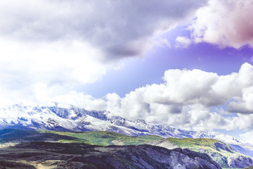 Obraz premium Colorful view of the mountain snow peaks under the clouds.