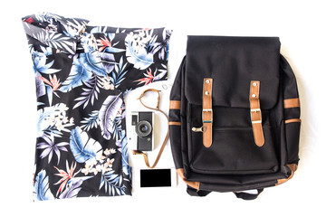 Flat lay travel set: straw, hipster retro camera, Summer vacation things neatly organised.