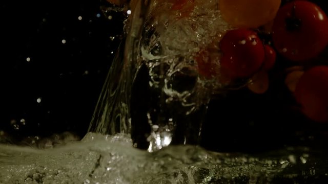 Water pouring and tomatoes falling, Ultra Slow Motion