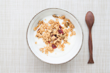 Yogurt with granola in ceramic bowl, Top view, Healthy and Diet concept