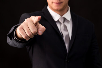 Businessman pressing on virtual screens isolated on black background