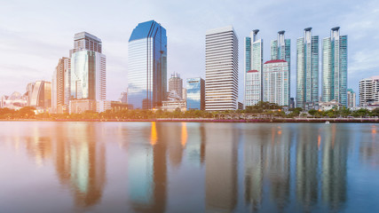 Office building water front with reflection at twilight, cityscape background