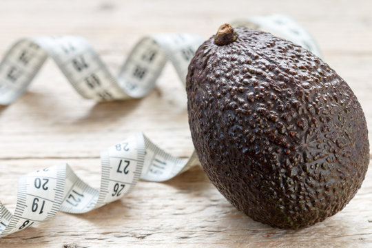 Fresh organic avocado Haas and measuring tape